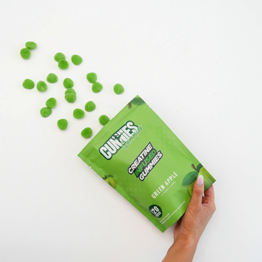 Green Apple Cunnies creatine gummies spilling from the bag